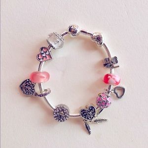 Pandora bracelet with pink charms symbolizing Breast Cancer.